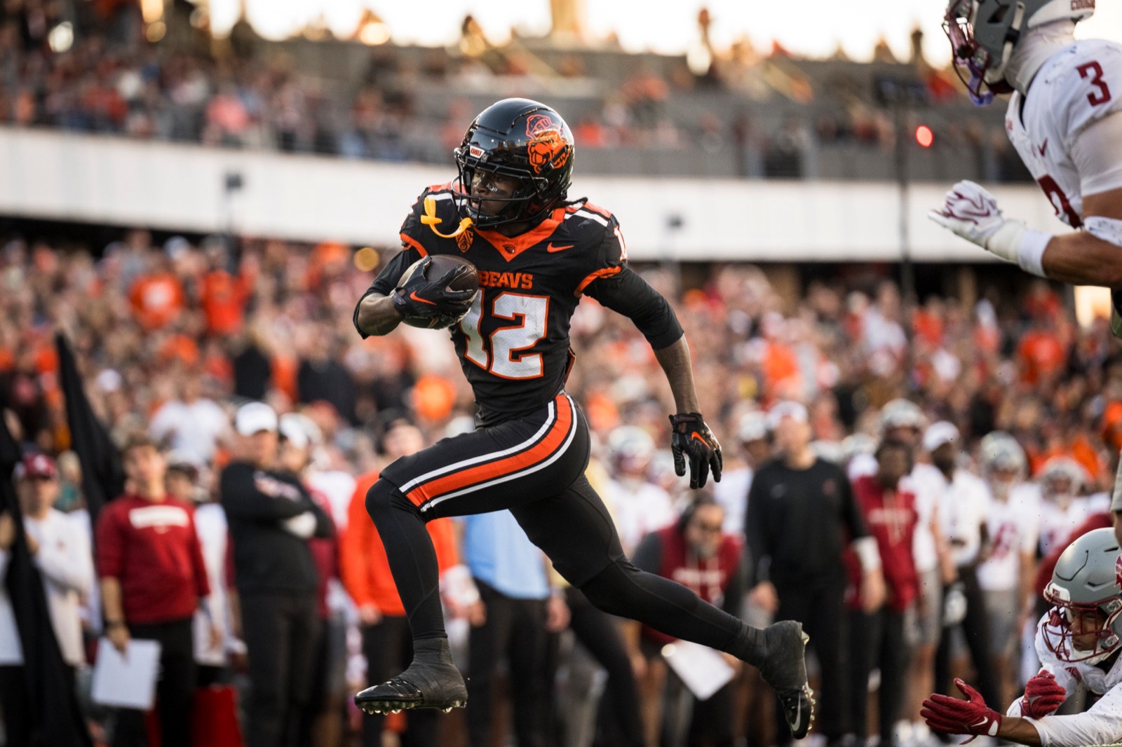 Jesse Legree carrying the ball toward the end zone against Washington State at Reser Stadium